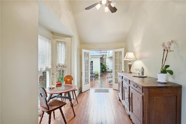 doorway featuring french doors, lofted ceiling, ceiling fan, and light hardwood / wood-style flooring