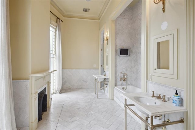 bathroom featuring a tub, sink, tile walls, and ornamental molding