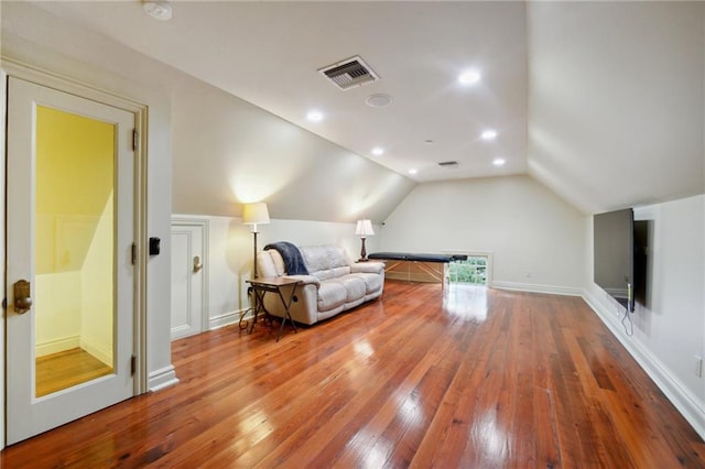 sitting room featuring vaulted ceiling and wood-type flooring