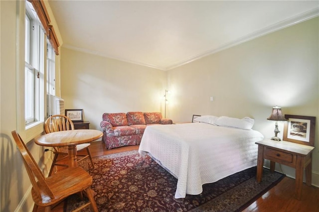 bedroom with wood-type flooring and ornamental molding