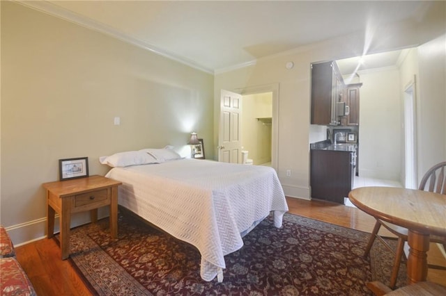 bedroom featuring dark wood-type flooring and crown molding