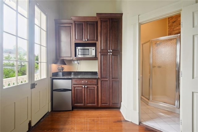 interior space featuring appliances with stainless steel finishes and light hardwood / wood-style floors