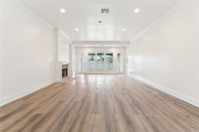 unfurnished living room featuring light wood-type flooring and crown molding