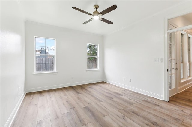 unfurnished room with ceiling fan, light wood-type flooring, and crown molding