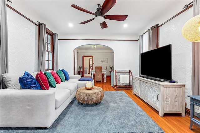 living room featuring light hardwood / wood-style flooring and ceiling fan