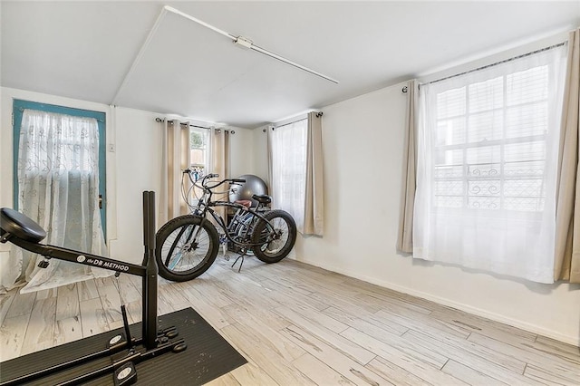 exercise room with light hardwood / wood-style flooring