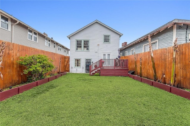 back of property featuring a yard and a deck