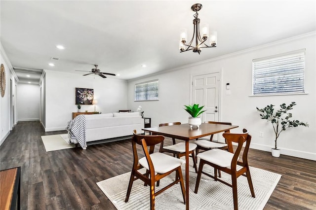 dining room featuring a healthy amount of sunlight, crown molding, and dark wood-type flooring