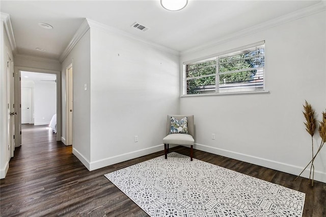 sitting room with crown molding and dark wood-type flooring