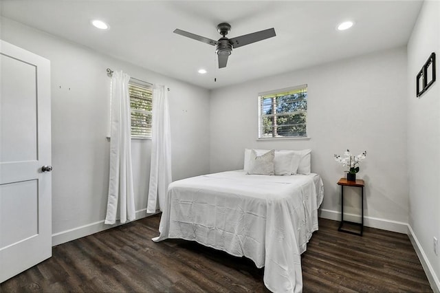 bedroom featuring multiple windows, ceiling fan, and dark hardwood / wood-style flooring