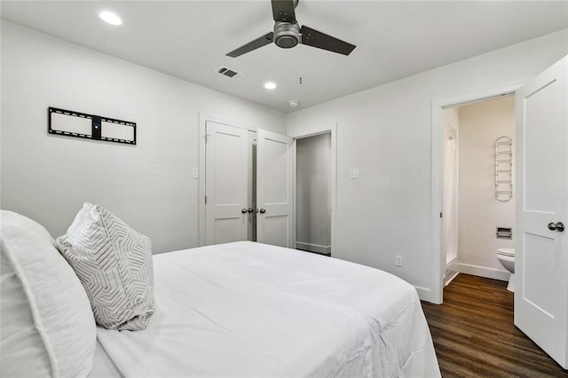 bedroom featuring connected bathroom, ceiling fan, and dark wood-type flooring