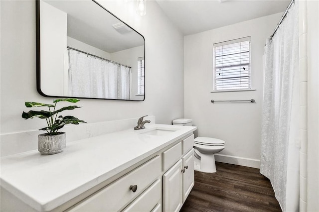 bathroom featuring wood-type flooring, vanity, and toilet