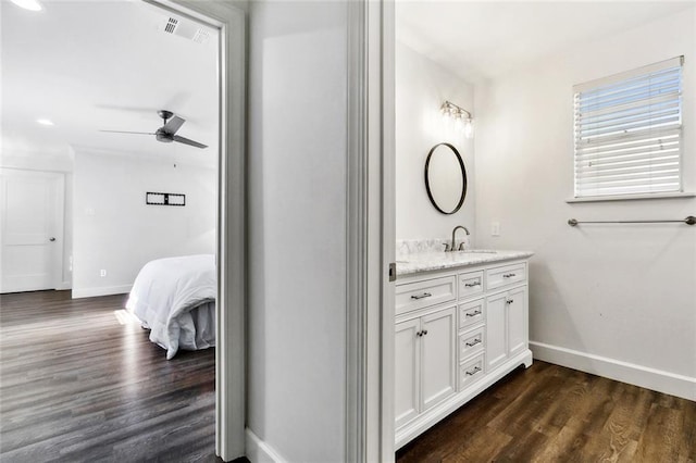 bathroom with ceiling fan, hardwood / wood-style floors, and vanity