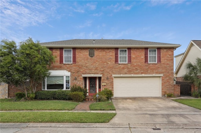 view of front of property with a front lawn and a garage