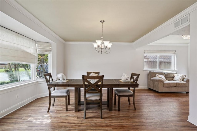 3733 Rockford Hts, Metairie, LA 70002 - dining space with ornamental molding, dark wood-type flooring, and an inviting chandelier