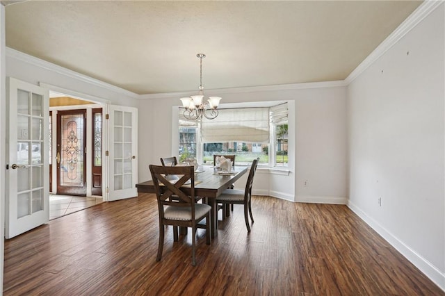 3733 Rockford Hts, Metairie, LA 70002 - dining area with french doors, dark hardwood / wood-style flooring, ornamental molding, and a notable chandelier