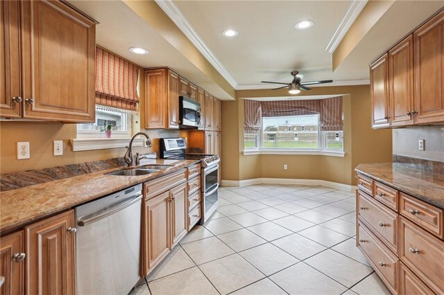 3733 Rockford Hts, Metairie, LA 70002 - kitchen with stainless steel appliances, ornamental molding, a ceiling fan, brown cabinets, and dark stone counters
