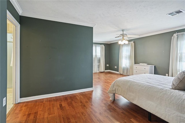 3733 Rockford Hts, Metairie, LA 70002 - bedroom featuring ceiling fan, hardwood / wood-style floors, crown molding, and a textured ceiling