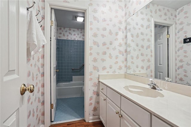 3733 Rockford Hts, Metairie, LA 70002 - full bathroom featuring hardwood / wood-style floors, vanity, toilet, and tiled shower / bath
