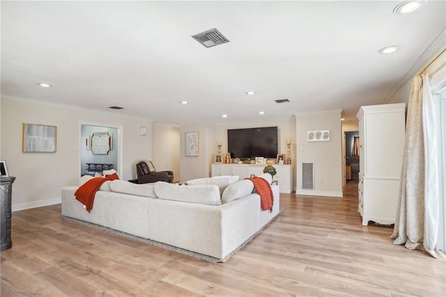 living room with light hardwood / wood-style flooring and ornamental molding