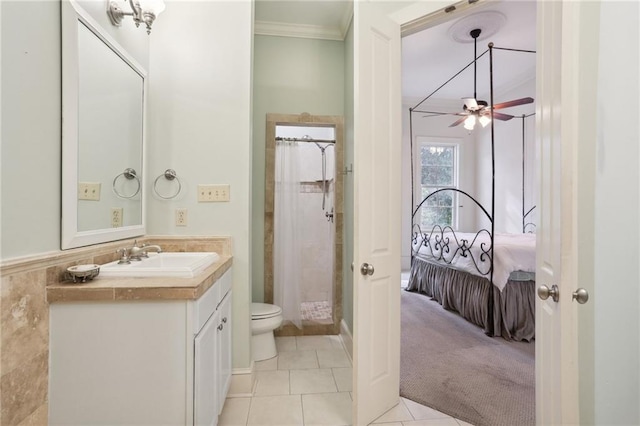 bathroom featuring a shower with shower curtain, vanity, ceiling fan, tile patterned flooring, and toilet