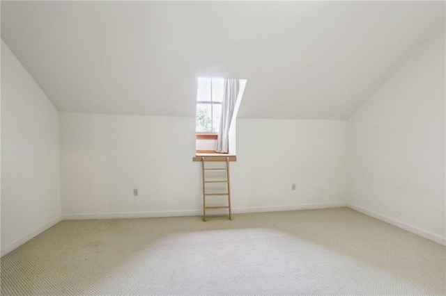 bonus room with carpet floors and vaulted ceiling