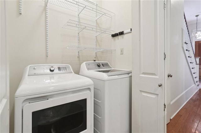 washroom featuring independent washer and dryer and dark wood-type flooring