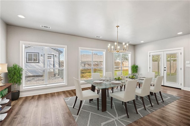 dining room featuring a notable chandelier, french doors, and dark hardwood / wood-style floors