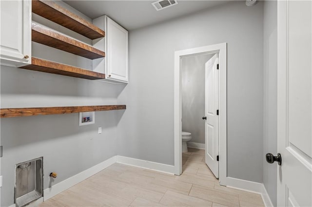 laundry room with cabinets and washer hookup