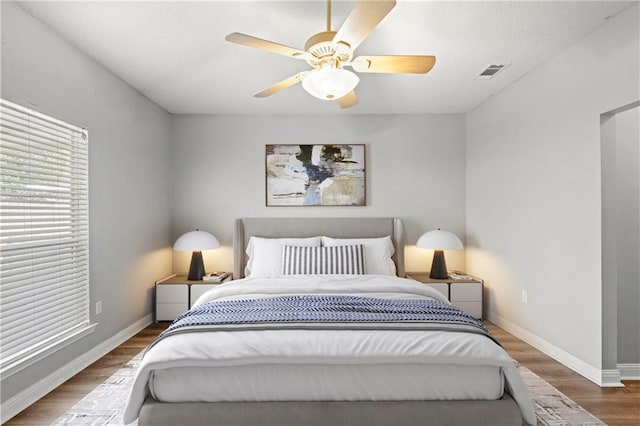 bedroom with ceiling fan and hardwood / wood-style flooring