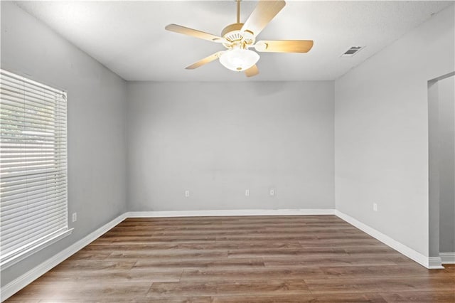 unfurnished room featuring hardwood / wood-style flooring and ceiling fan