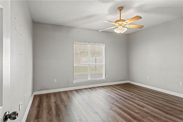 spare room featuring ceiling fan, a textured ceiling, and dark hardwood / wood-style floors