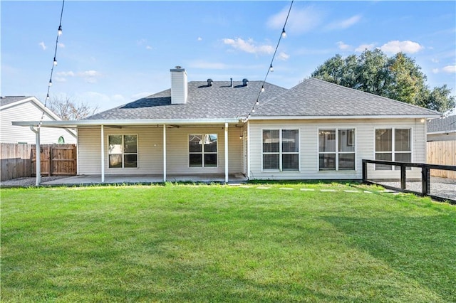 back of property featuring a patio and a yard