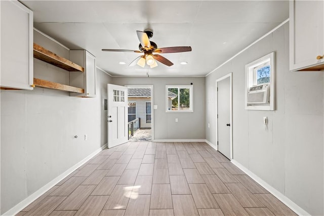 spare room with ceiling fan, cooling unit, and crown molding