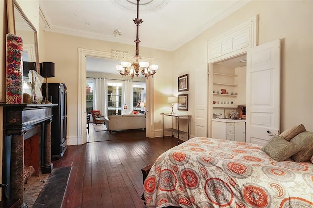 bedroom featuring a notable chandelier, ornamental molding, and dark wood-type flooring