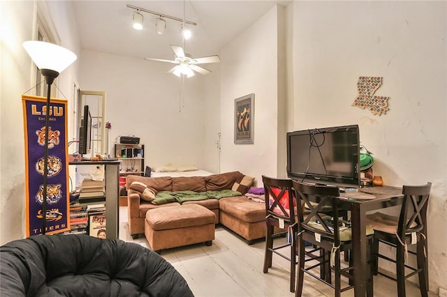 living room with ceiling fan and light hardwood / wood-style flooring