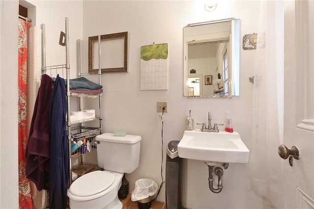 bathroom with tile patterned floors, sink, and toilet