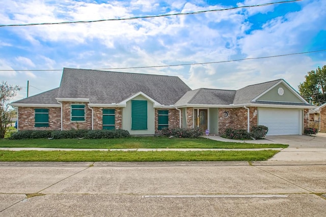 ranch-style house featuring a front yard and a garage