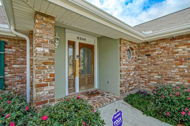 6300 W Metairie Ave, Metairie, LA 70003 - property entrance featuring brick siding, roof with shingles, and stucco siding