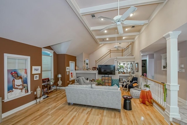 living room with beamed ceiling, light wood-type flooring, decorative columns, and ceiling fan