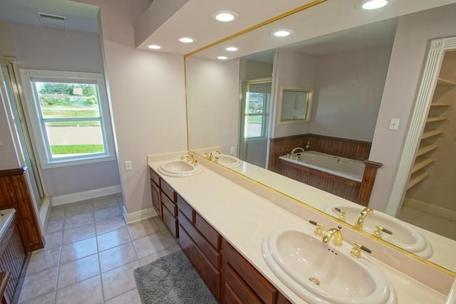 bathroom featuring vanity, tile patterned floors, and separate shower and tub