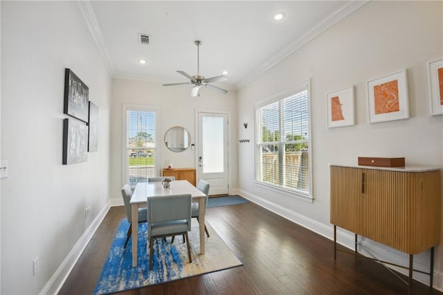 dining room with crown molding, dark hardwood / wood-style flooring, and ceiling fan