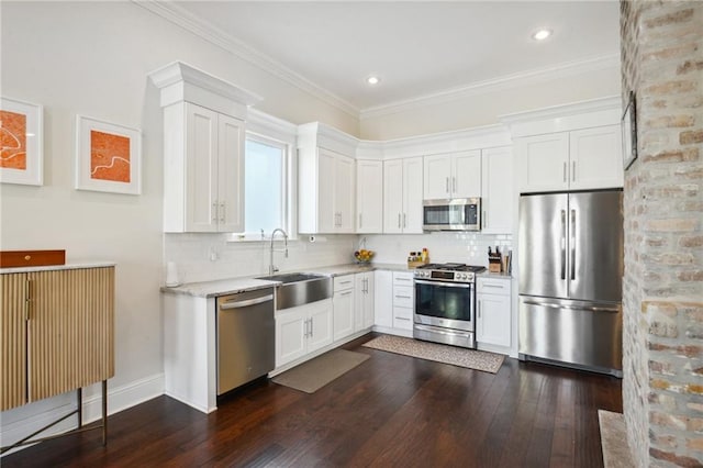 kitchen with white cabinets, appliances with stainless steel finishes, dark wood-type flooring, and sink