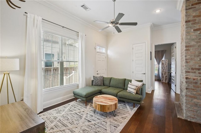 living room with dark hardwood / wood-style floors, ceiling fan, and crown molding