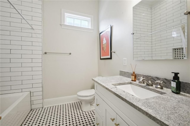 full bathroom featuring vanity, toilet, and tiled shower / bath