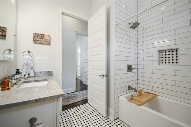 bathroom featuring vanity and tiled shower / bath