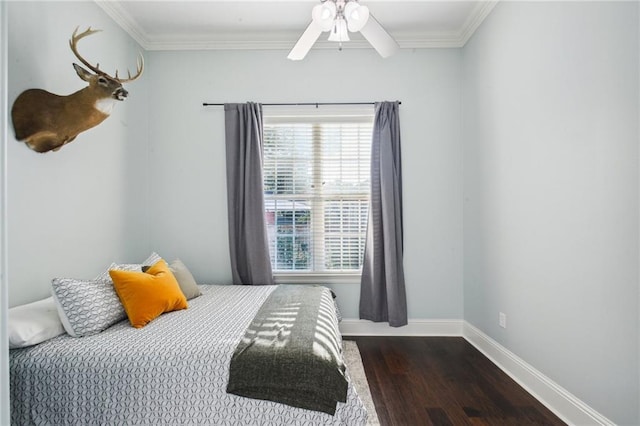 bedroom with crown molding, ceiling fan, and dark wood-type flooring