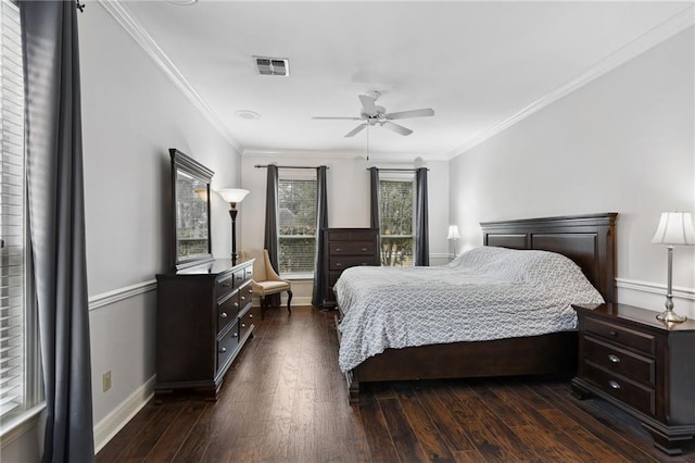 bedroom featuring dark hardwood / wood-style flooring, ceiling fan, and ornamental molding