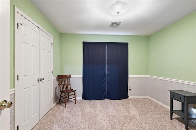 sitting room featuring light carpet