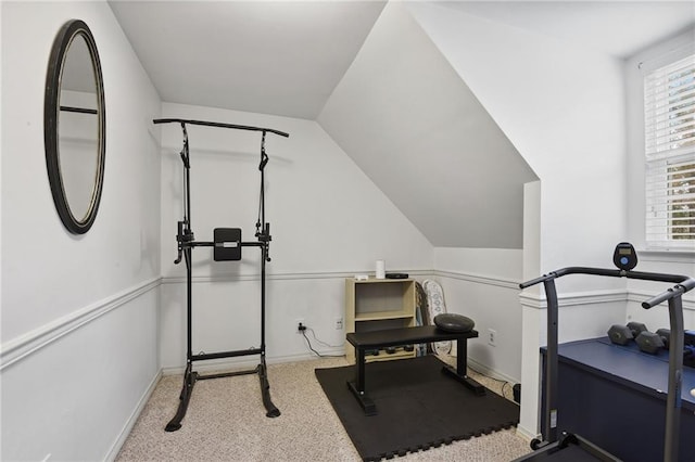 exercise room with a wealth of natural light, light carpet, and lofted ceiling